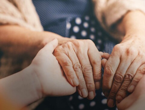Doctor holding patient's hands