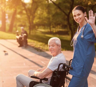Senior caucasian male patient in a wheelchair with a female nurse