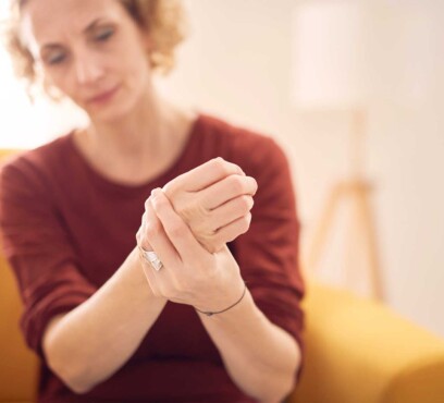 Caucasian female patient holding her clenched fist